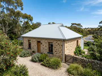Stone cottage with a brand-new light grey corrugated steel roof